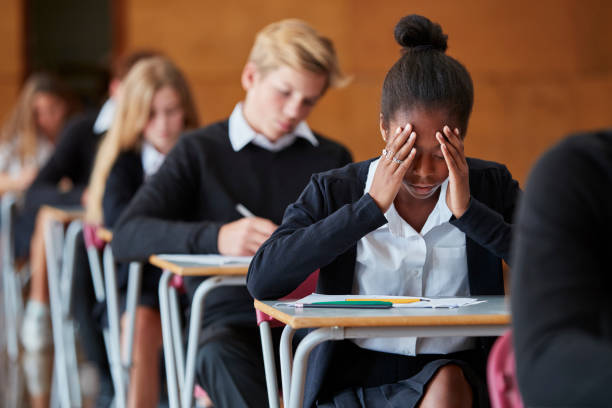 Anxious Teenage Student Sitting Class 10 Examination In School Hall