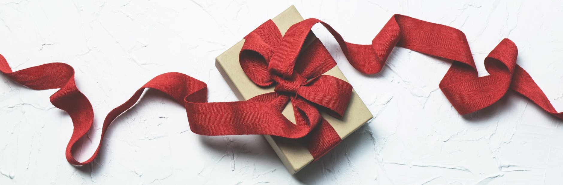 Red gift box with ribbon. Gifts for Christmas