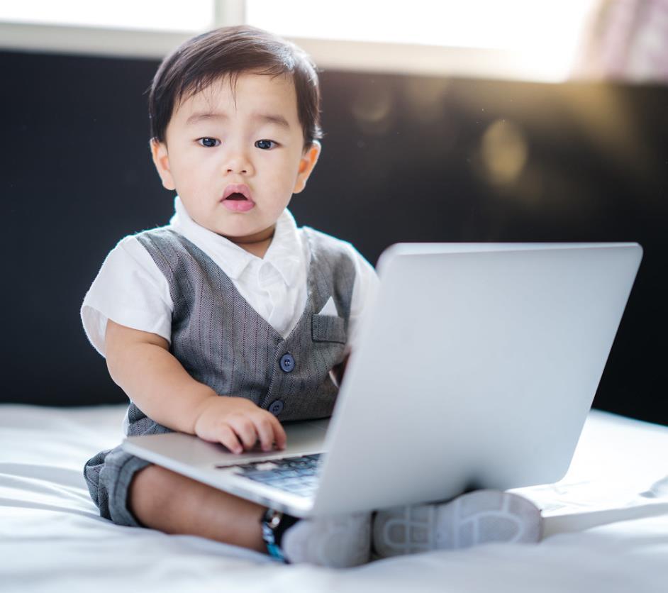 Asian tech-savvy baby in business concept use computer laptop. Talented cute baby boy, technology,  notebook.