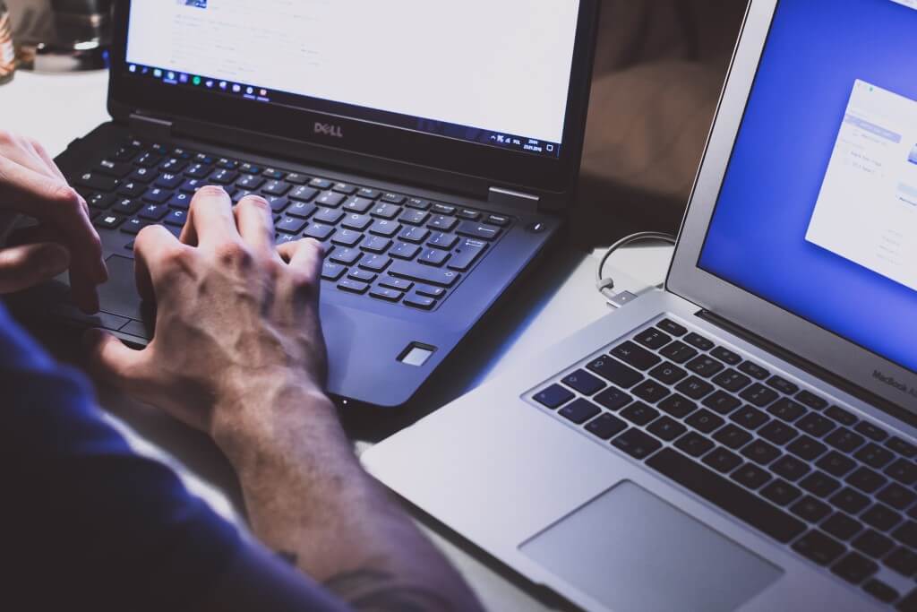 Man Working on Refurbished Dell Laptop.