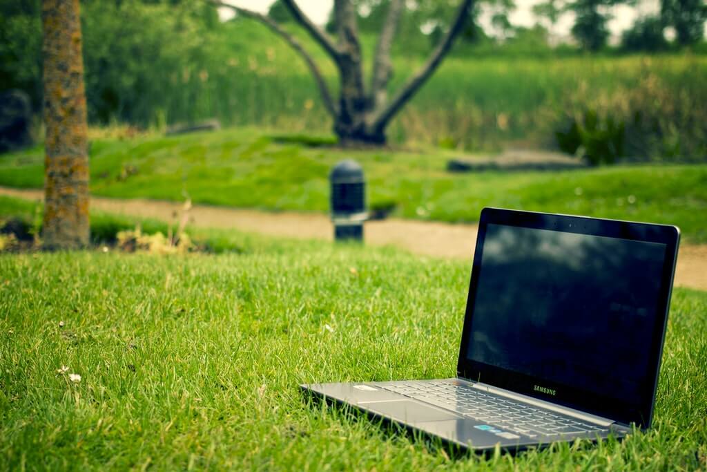 Gray and Black Laptop Computer on Grass Lawn Outdoors. Free Stock Photo
