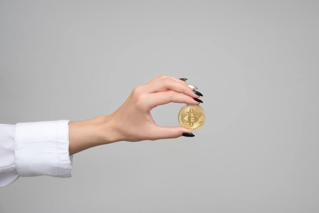Woman holding a bitcoin cryptocurrency. 