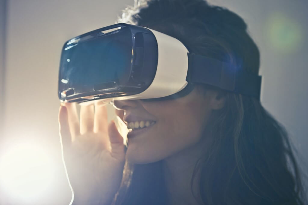 Woman wearing virtual reality goggles. Top Tech Trends in Education - Virtual Reality Technology.