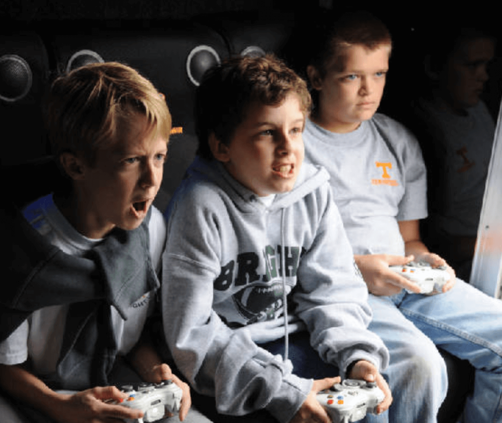 Three children playing console video games.