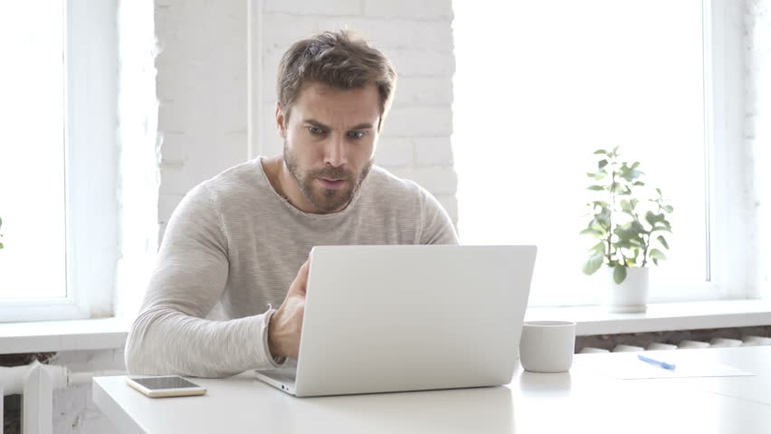 Man Blogging on a Laptop Computer. 