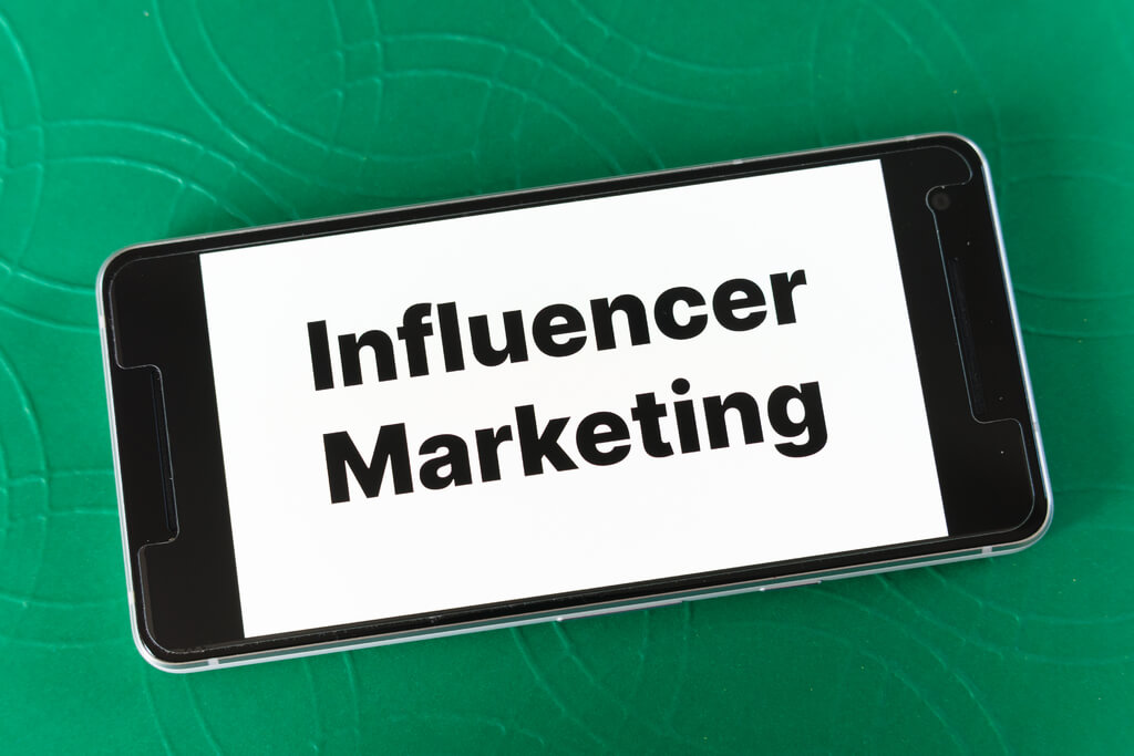 The Word Influencer Marketing on a Smartphone Screen.
