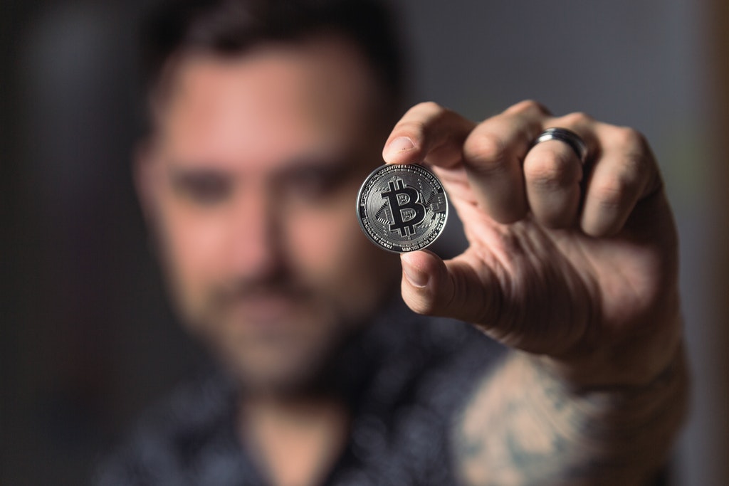 Bitcoin Trader or Person Holding Silver Bitcoin Coin.