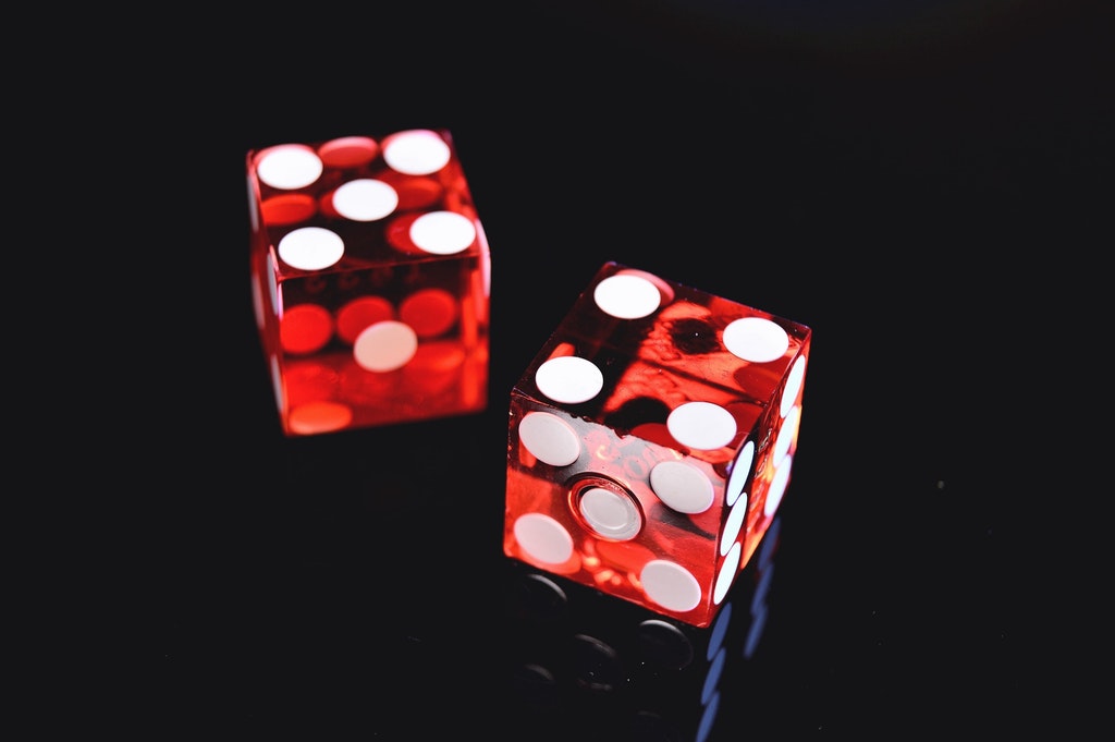 Closeup photo of two red dices showing 4 and 5.