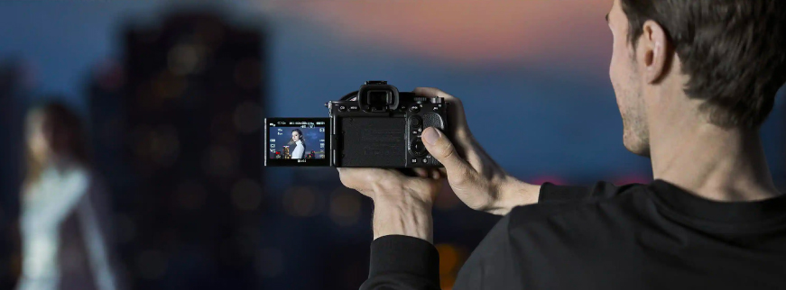 Man holding Sony Alpha 7S III camera  recording a video.