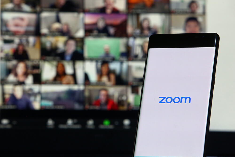 Zoom logo and Zoom meeting on Laptop