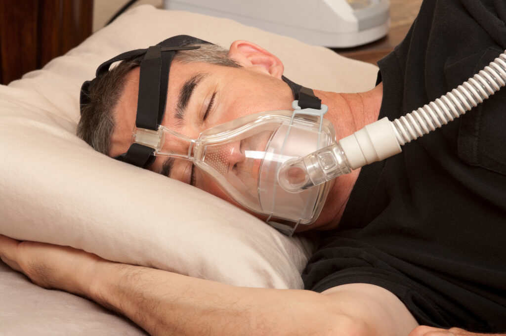 Man with Sleep Apnea and CPAP Machine