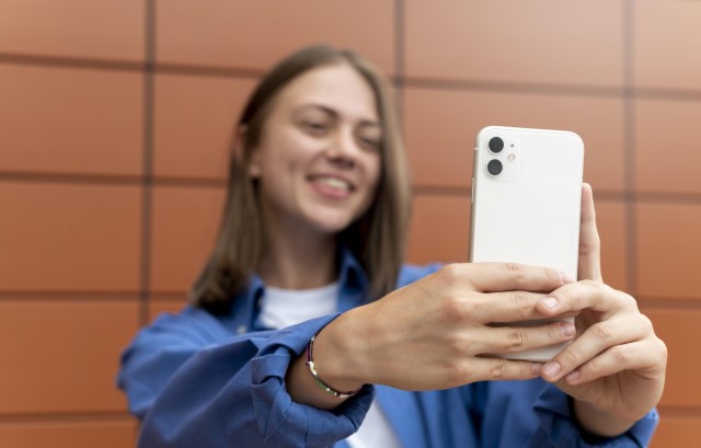 Young girl holding her mobile phone