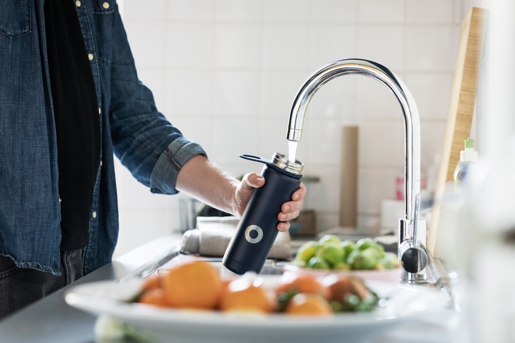 person holding stainless steel faucet photo