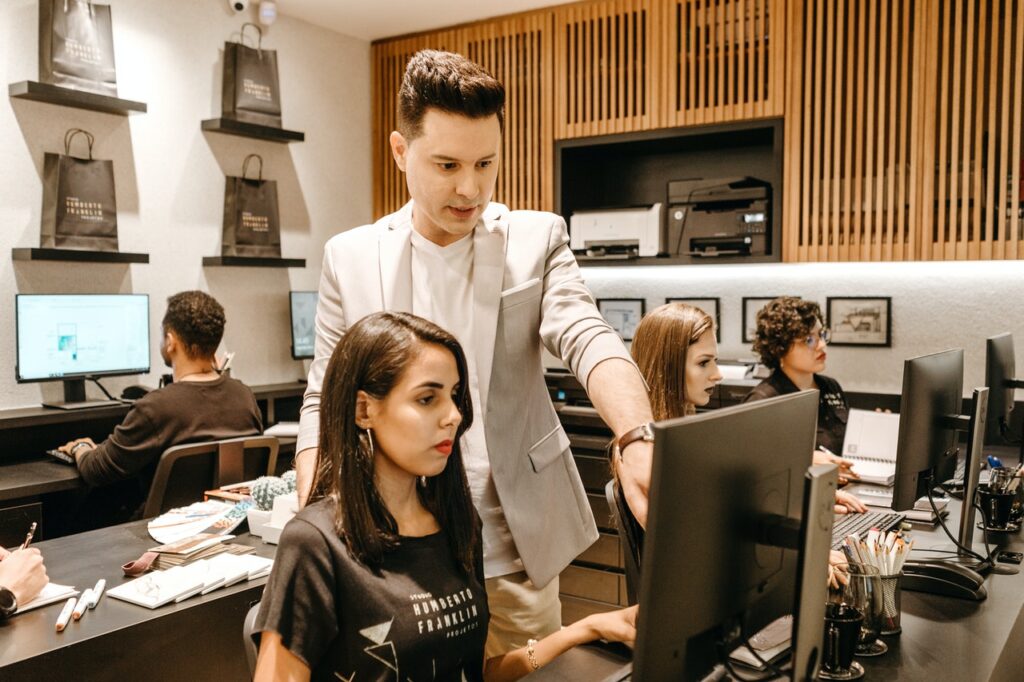 Increase the Efficiency of Employees, Man Teaching Woman in Front of Monitor