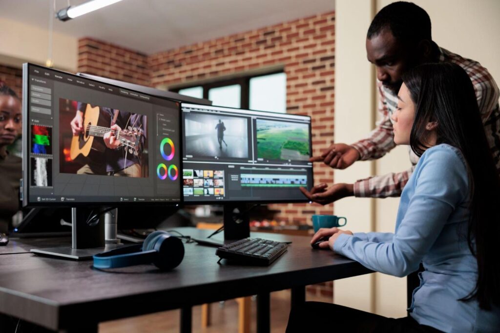 Professional video editor sitting at multi monitor workspace while enhancing movie footage quality using advanced software. Post production house team leader editing film frames.