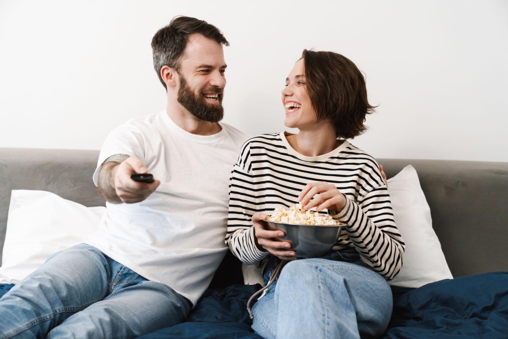 Happy Young Couple Watching TV