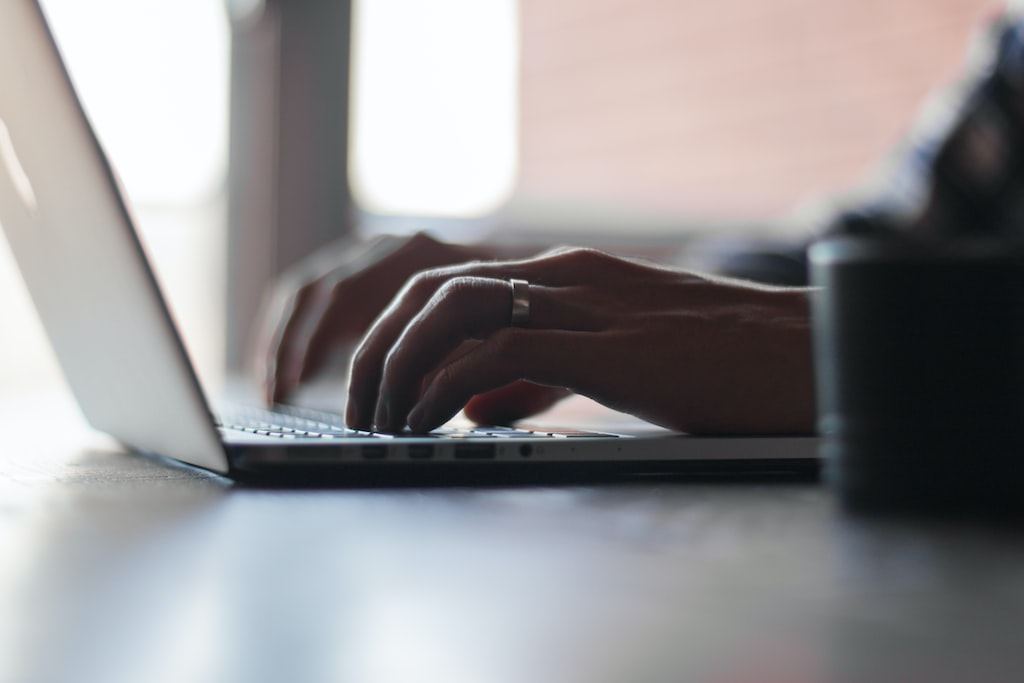 Person using Mac laptop photo