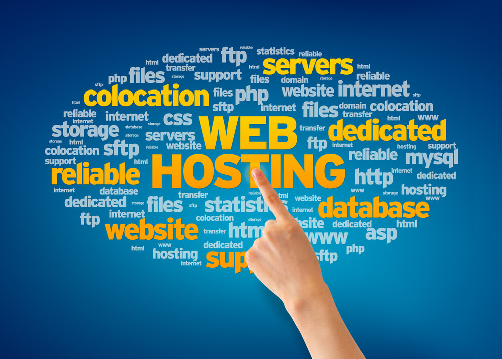 Hand Pointing at a Web Hosting Word Cloud on Blue Background