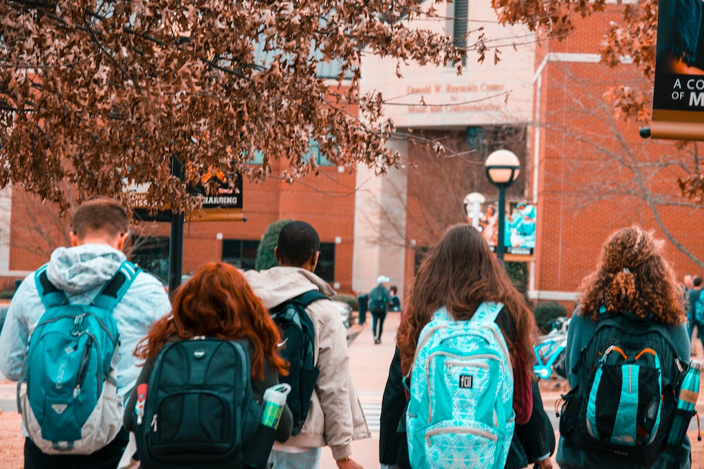College Students Wearing Backpacks Walking
