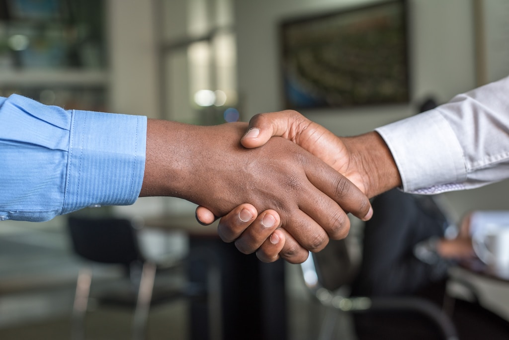 Two people shaking hands in job interview