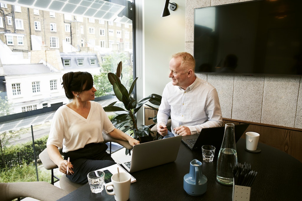 Businessman and Businesswoman discussing and sharing ideas