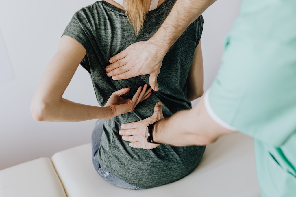 Doctor Examines Woman's Back Pain