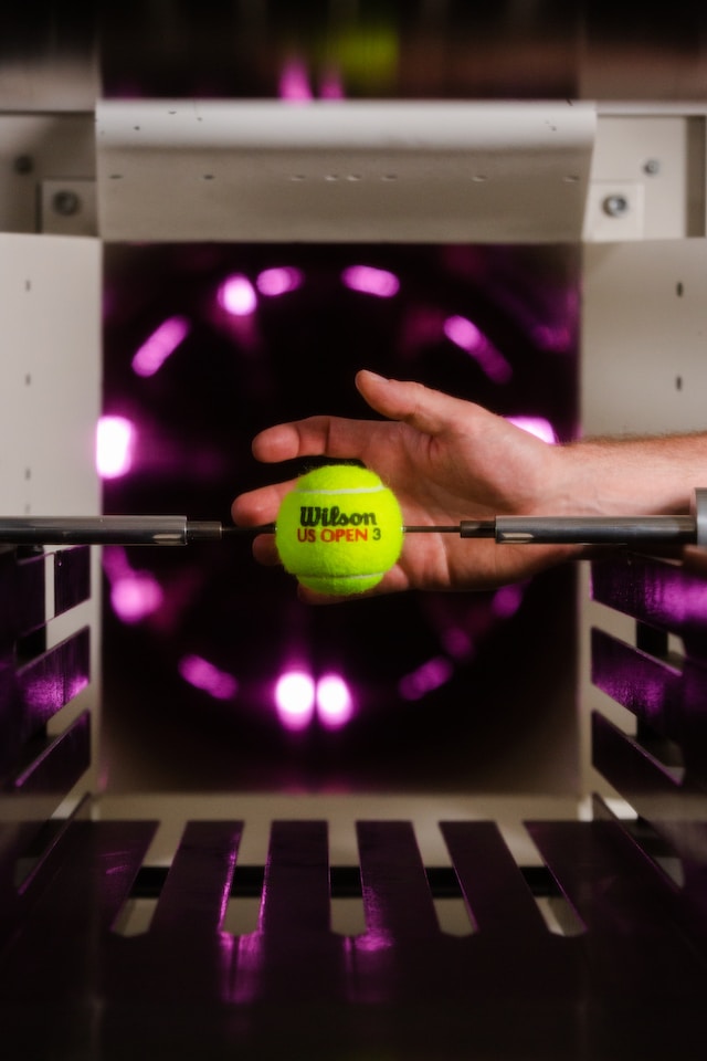 Male sports engineer tests tennis equipment