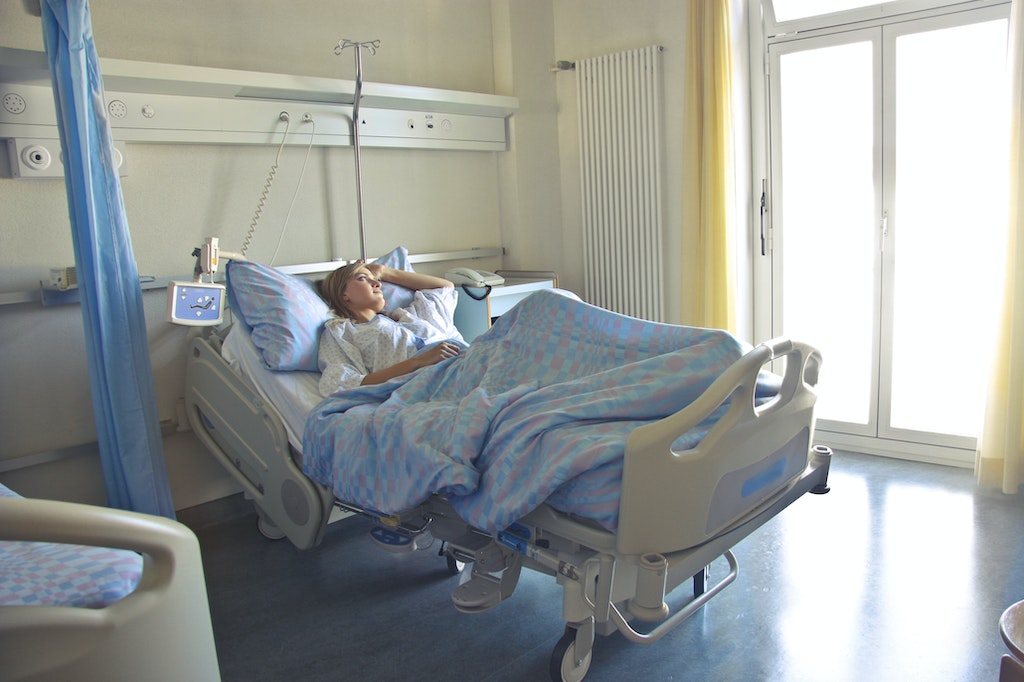 Photo of woman lying in hospital bed