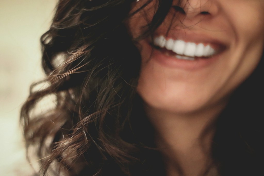 Long black haired woman smiling close up photography
