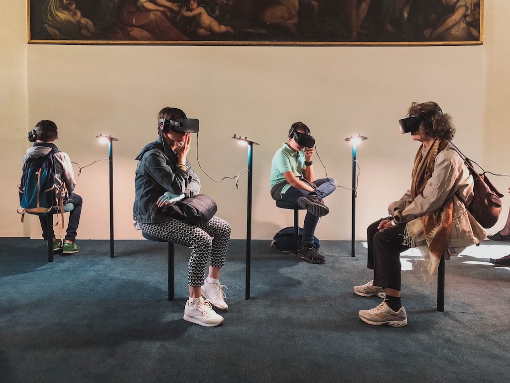 Four person playing virtual reality goggles, future tech.