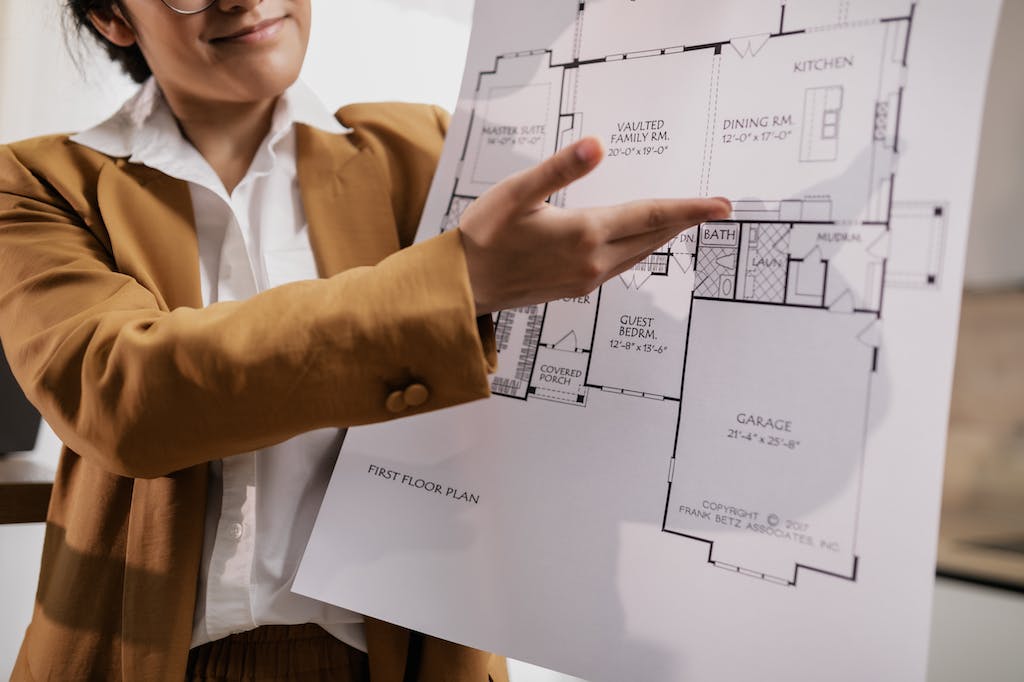 A Real Estate Agent (or Realtor) Presenting a Blueprint