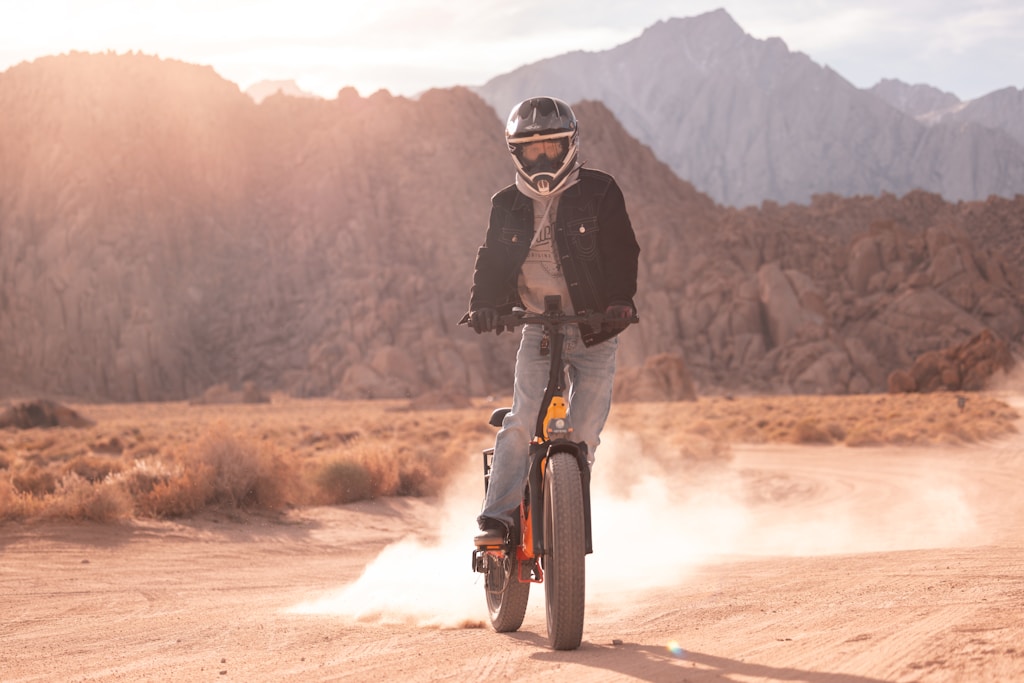 A person riding a e-bike electric bike on a dirt road.