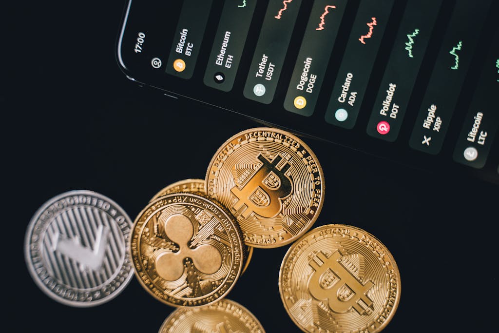 Cryptocurrency Coins Bitcoins Beside a Phone